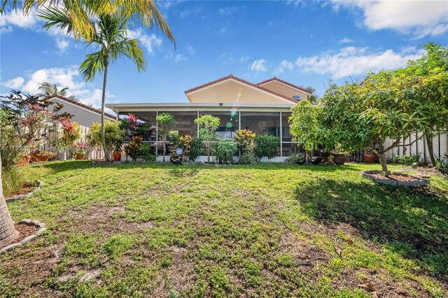 1249 NW 126th Ter, Sunrise, FL 33323 - back of property with a sunroom and a lawn