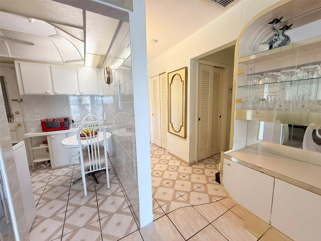 interior space featuring tile patterned flooring and a closet