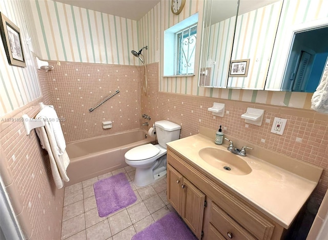 full bathroom featuring toilet, tile walls, tile patterned floors, shower / bath combination, and wallpapered walls