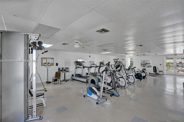 workout area featuring ceiling fan, a drop ceiling, and visible vents