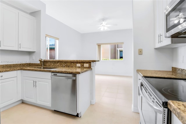 kitchen with a sink, ceiling fan, white cabinetry, and appliances with stainless steel finishes