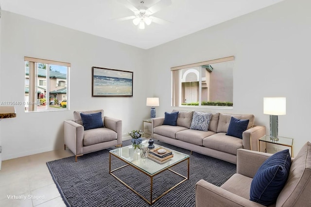 living area with a ceiling fan and tile patterned floors