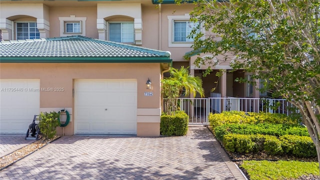 view of front of property with stucco siding and decorative driveway