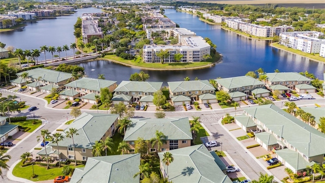 drone / aerial view featuring a water view and a residential view