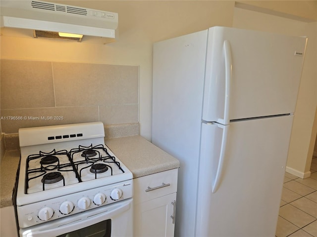 kitchen with light tile patterned floors, extractor fan, white cabinets, white appliances, and light countertops