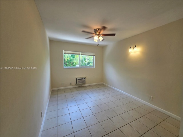 spare room with ceiling fan, light tile patterned floors, baseboards, and a wall unit AC