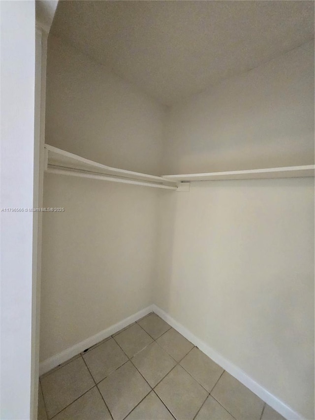 spacious closet featuring light tile patterned flooring