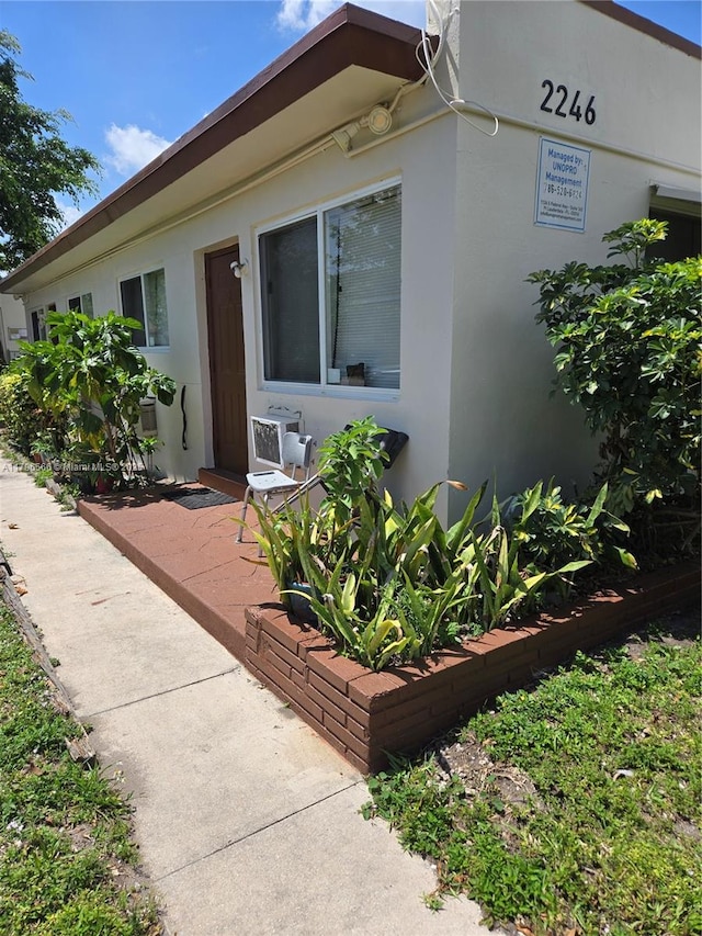 property entrance featuring stucco siding