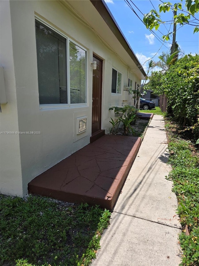 view of home's exterior featuring a patio area, stucco siding, and fence