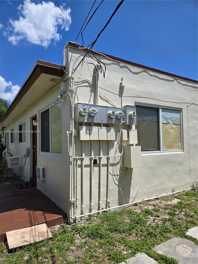 view of side of property featuring a deck and stucco siding
