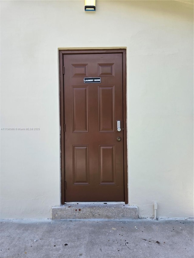 doorway to property featuring stucco siding
