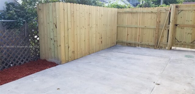 view of patio with a gate and fence