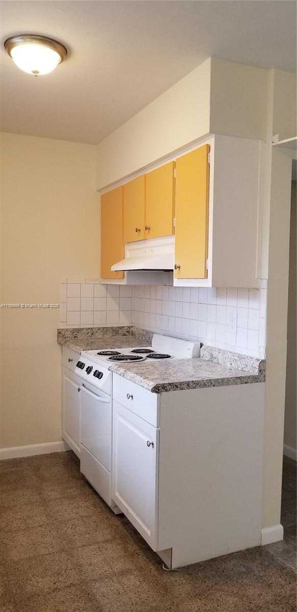 kitchen with light countertops, white electric range, decorative backsplash, and under cabinet range hood