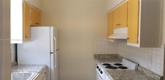 kitchen featuring a sink, white appliances, backsplash, under cabinet range hood, and light countertops