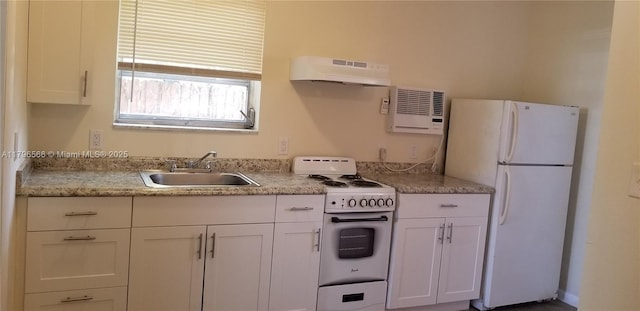 kitchen featuring under cabinet range hood, white cabinetry, white appliances, and a sink