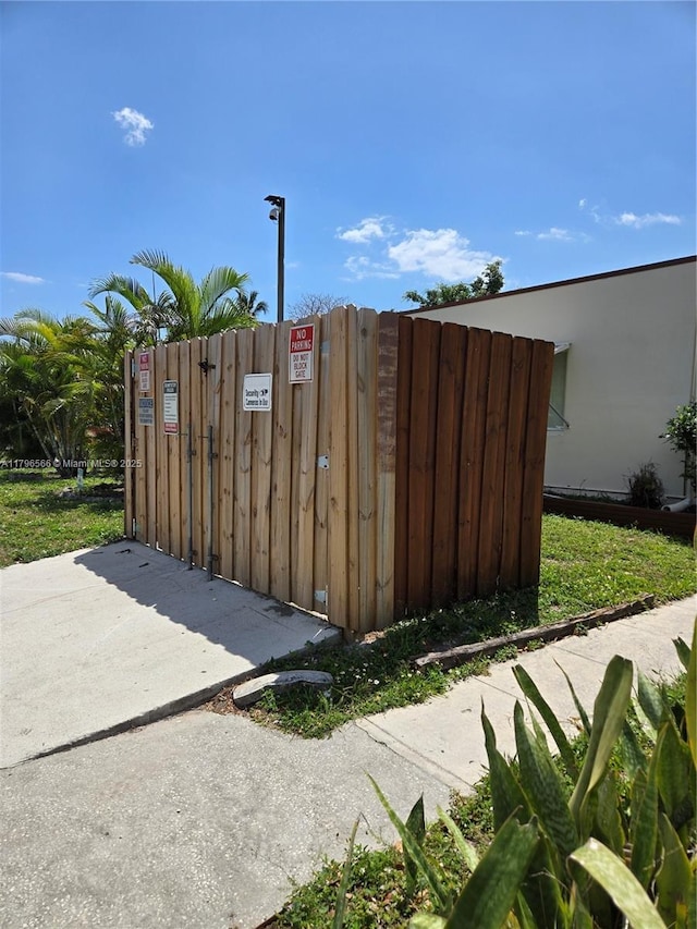 view of outdoor structure with fence and a gate