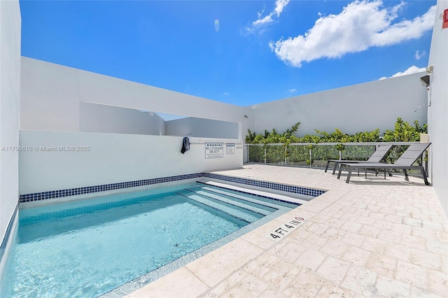 community pool with a patio area