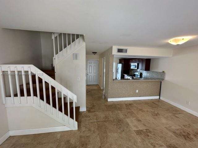 stairs featuring baseboards and visible vents