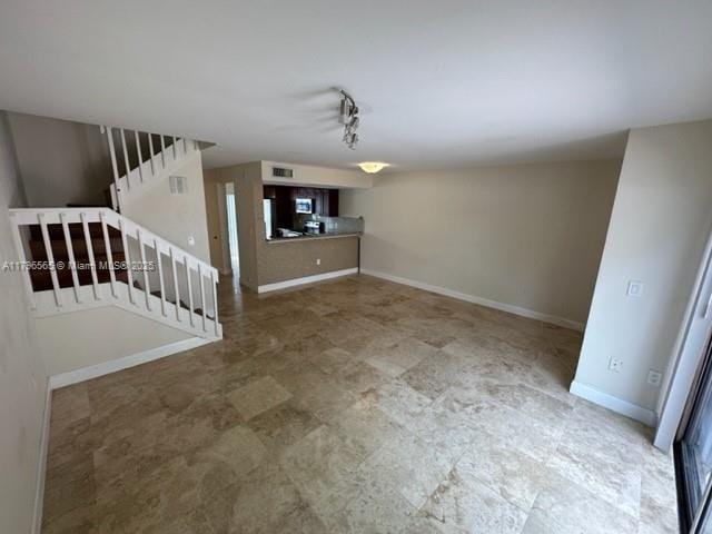interior space featuring stairway and baseboards