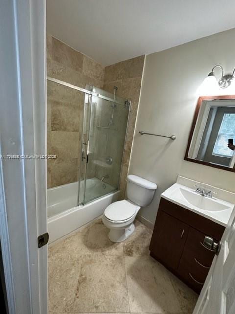 full bathroom with toilet, vanity, and shower / bath combination with glass door
