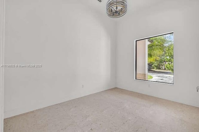 spare room featuring a notable chandelier