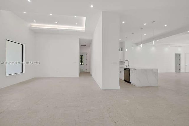 interior space with a towering ceiling, a sink, and recessed lighting