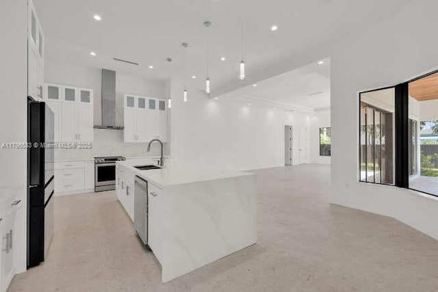 kitchen with a sink, a spacious island, white cabinetry, range hood, and appliances with stainless steel finishes