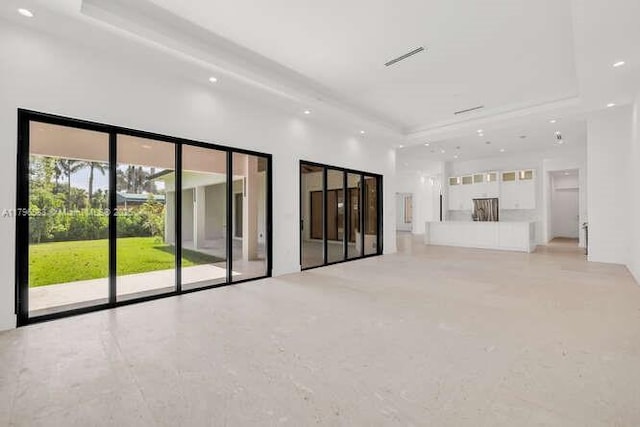 unfurnished living room featuring recessed lighting