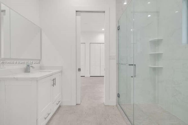 bathroom with a stall shower and vanity