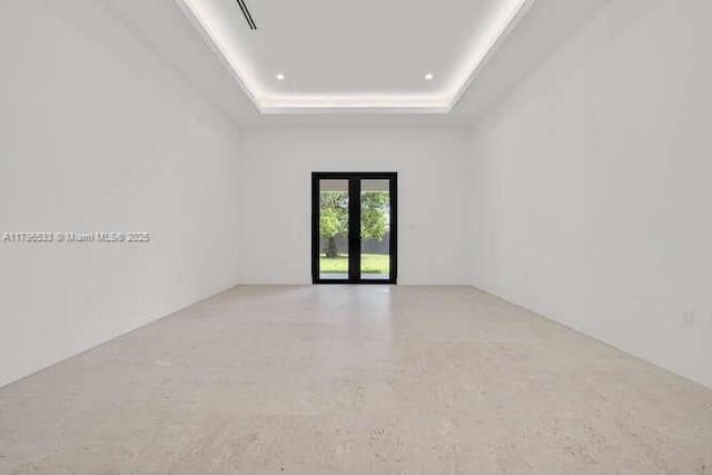 spare room with a raised ceiling