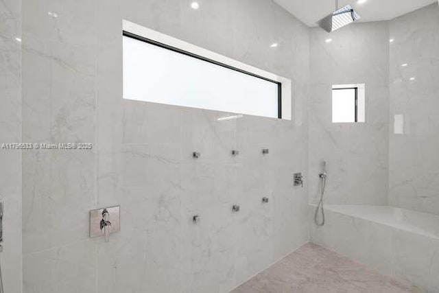 bathroom with a marble finish shower