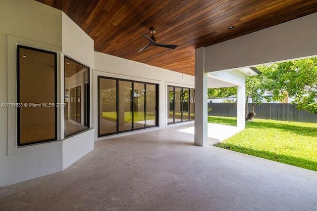 view of patio / terrace with ceiling fan and fence
