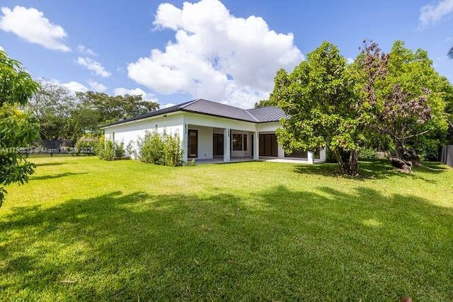 back of house with a lawn