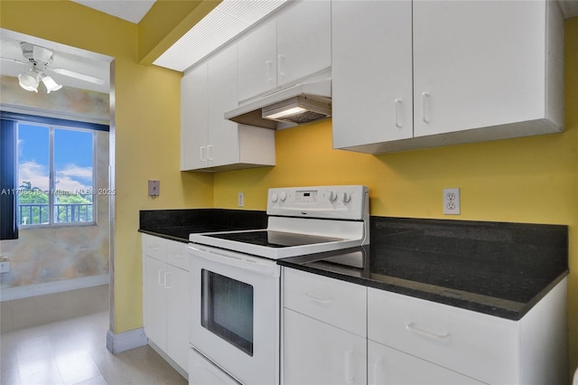kitchen with white electric range oven, a ceiling fan, white cabinets, baseboards, and under cabinet range hood