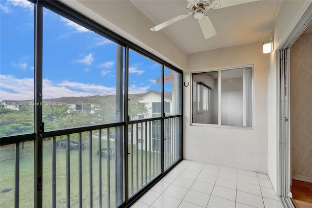 unfurnished sunroom with ceiling fan