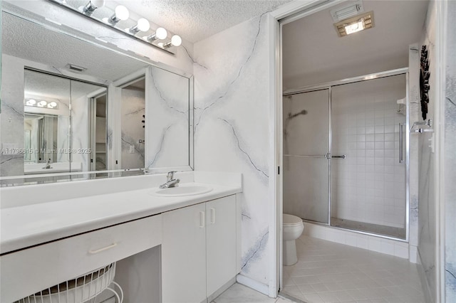 full bathroom with toilet, vanity, a textured ceiling, visible vents, and a shower stall