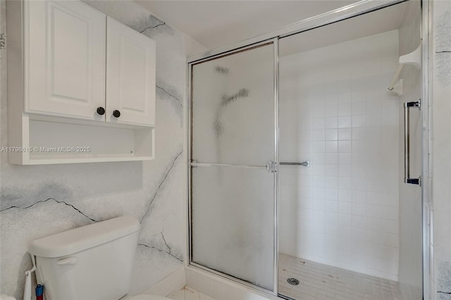 full bathroom with a stall shower and toilet