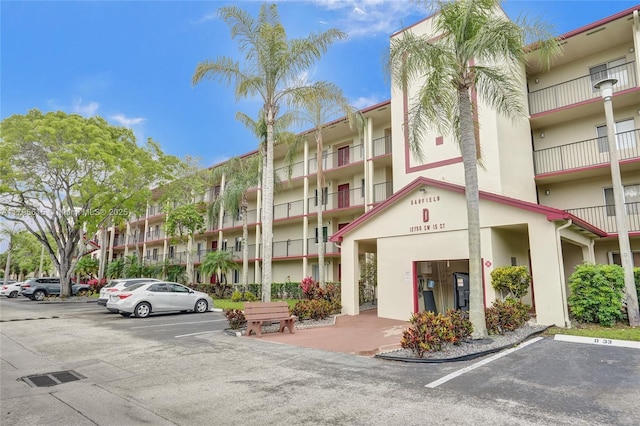 view of property featuring uncovered parking