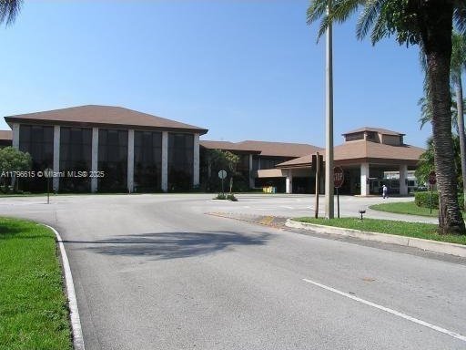 12750 SW 15th St Unit 411D, Pembroke Pines, FL 33027 - view of road with curbs and traffic signs