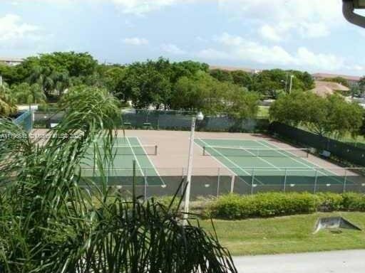 view of tennis court featuring fence