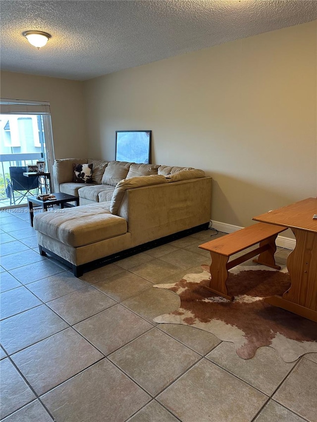 tiled living room with baseboards and a textured ceiling