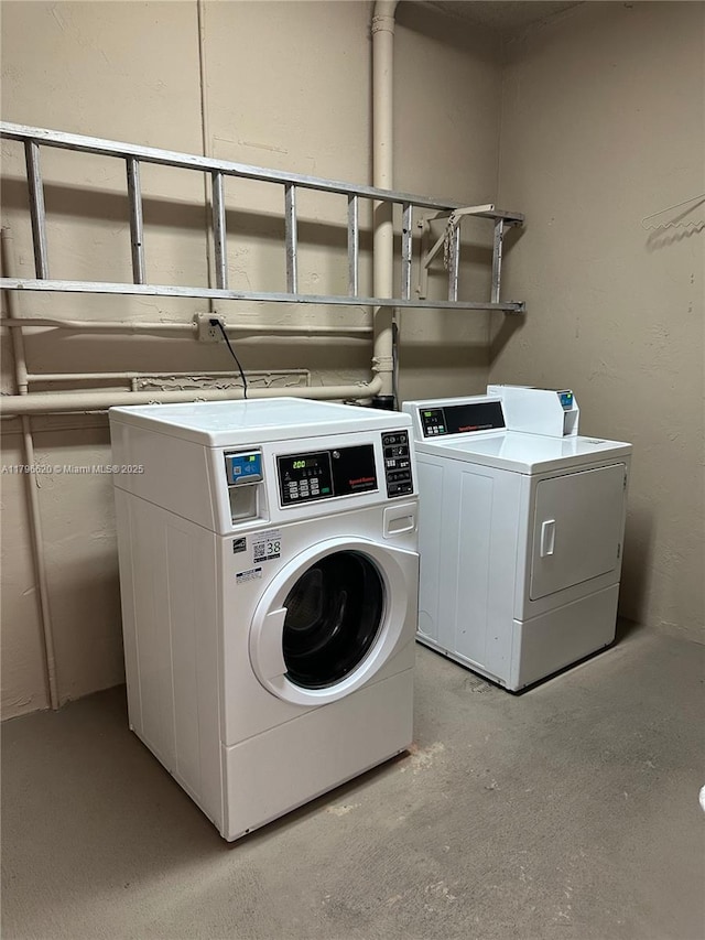 community laundry room featuring separate washer and dryer