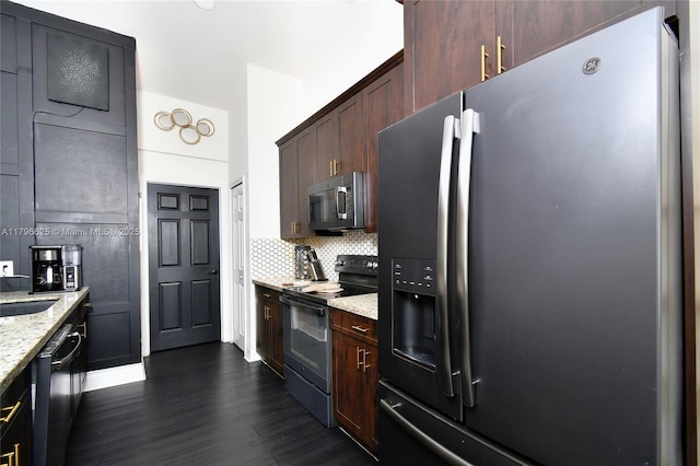 432 Piedmont St, Lehigh Acres, FL 33974 - kitchen featuring stainless steel appliances, dark wood-type flooring, light stone countertops, tasteful backsplash, and dark brown cabinets