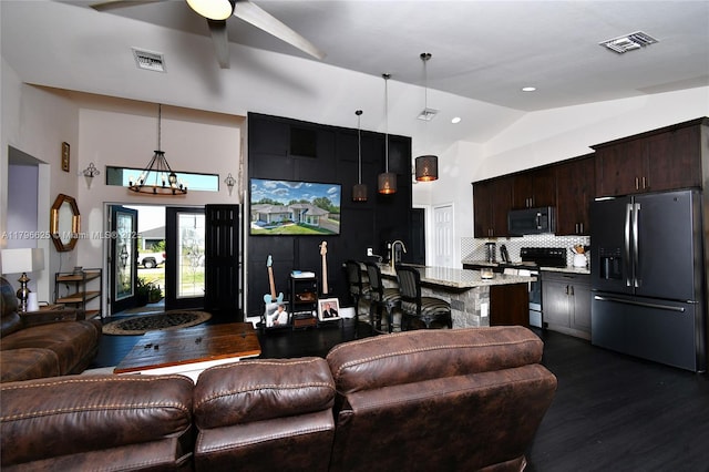 432 Piedmont St, Lehigh Acres, FL 33974 - living room with dark wood-type flooring, ceiling fan, a chandelier, and high vaulted ceiling