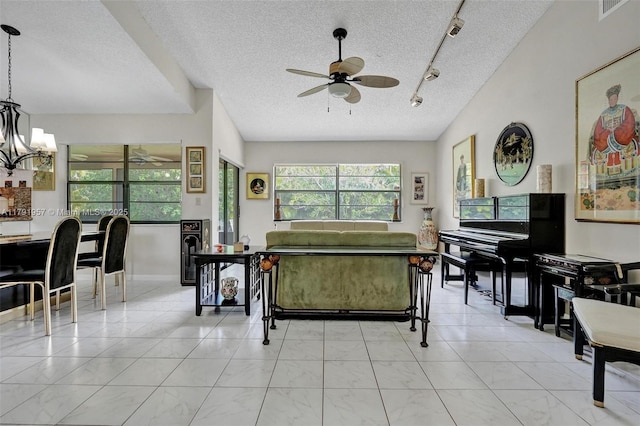 8215 NW 85th Ave, Tamarac, FL 33321 - living room featuring track lighting, visible vents, a textured ceiling, and ceiling fan with notable chandelier