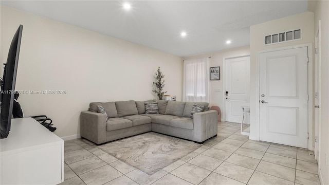 living area featuring baseboards, light tile patterned floors, visible vents, and recessed lighting