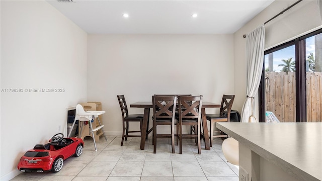 dining area featuring light tile patterned flooring and recessed lighting
