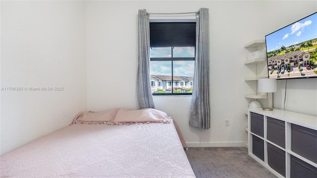bedroom with baseboards, multiple windows, and light carpet