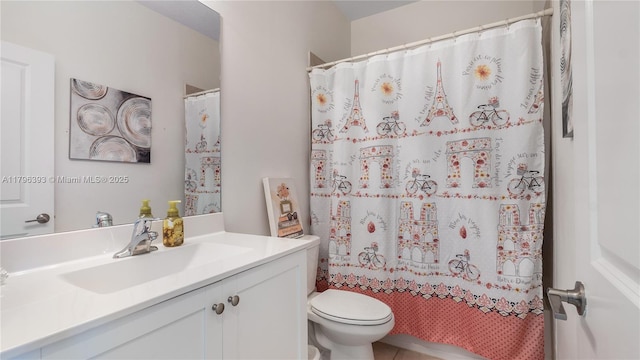 bathroom featuring toilet, tile patterned floors, vanity, and curtained shower
