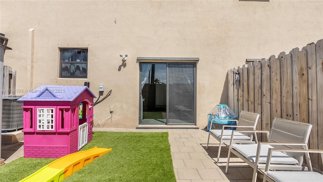 back of house with fence, stucco siding, and a patio area